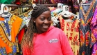 African american woman with clothes behind her