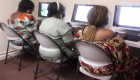 group of woman in front a computer